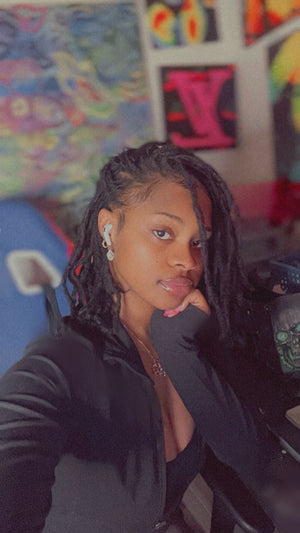 Lay Simone artist and founder of TheLaySimone.com surrounded by her original artwork in Pittsburgh, Pa.